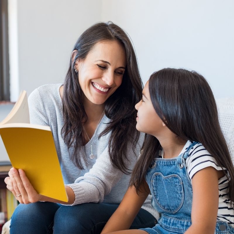 Mother reading book with child